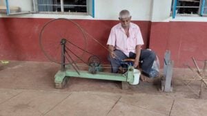 Udupi cotton weaver charkha yarn winding Talipady handloom preparation Karnataka man