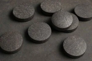 Collection of small circular Wootz steel cakes approximately 12 centimetres diameter from South India Konasamudram Telangana the raw export form of Damascus steel traded to Persia and medieval world